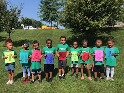 Horizons students holding a THANK YOU sign